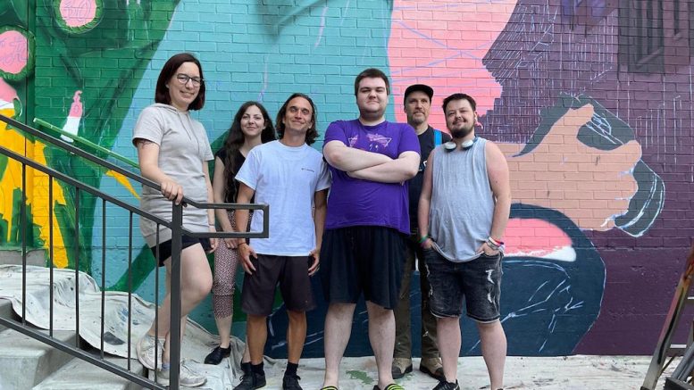 Demetry Cloutier, Maxime Leclerc, Josée-Ann, Josuha Paquet-Lévesque, Clémentine Ogier, et Patrick Forchild, devant la murale du CJC en cours de réalisation. (Crédit photo : Estelle Lévêque)